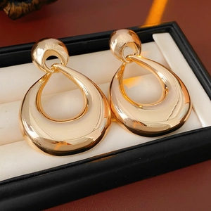 Close-up of vintage golden teardrop earrings in a black gift jewelry box