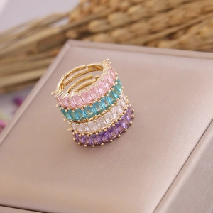 Macro view of four-piece gold ring set featuring colorful rectangular zircon stones