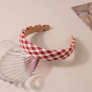 Detailed view of red and white plaid padded headband with textured wool material