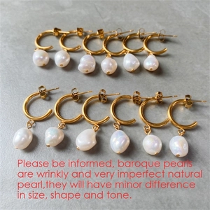 Detailed view of baroque pearls on gold stainless steel earrings with natural textures