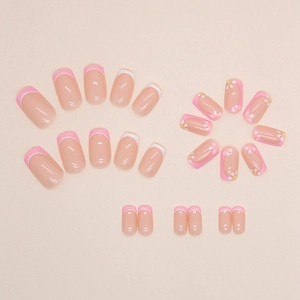 Pink French press-on nails with white daisy floral patterns in a square-oval shape