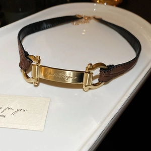 Detailed macro view of the brushed gold plaque and leather texture on this ethnic choker