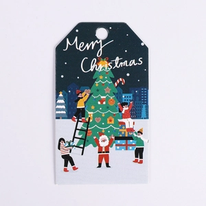 Close-up of Christmas tree illustration and Merry Christmas text on a gift tag