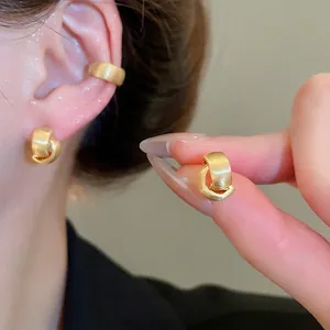 Elegant matte gold double interlocking C-shaped hoop earrings for women with brushed metal