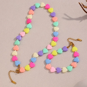 Macro shot of colorful heart-shaped beads and pearls with a K18 gold lobster clasp