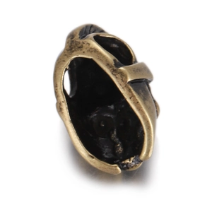 Macro shot of 18K gold plated skull charm bead with intricate hollow design for jewelry