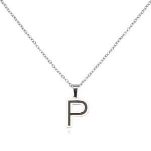 Macro detail of silver-toned stainless steel pendant featuring black enamel capital letter P