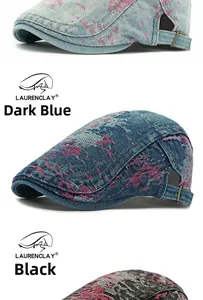 Detail view of washed denim beret featuring pink frayed patterns and side metal buckles