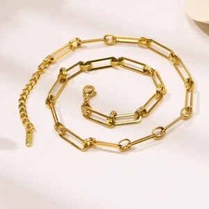 Detail view of gold rectangular link chain with lobster clasp and 18K hallmark engraving