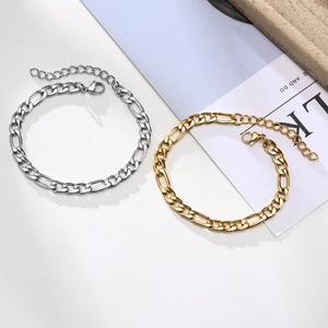 Detail of gold and silver Figaro chains showing flat links and secure lobster clasps