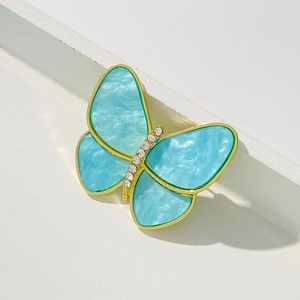 Elegant natural shell butterfly brooch with blue marble wings and gold-plated rhinestones