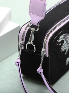 Matte black and purple butterfly crossbody camera bag with lavender strap and dual zippers