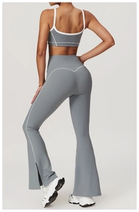 Rear view of grey yoga set featuring cross-back vest and flared leggings with white piping