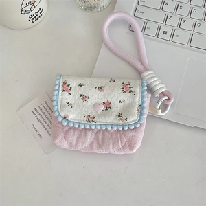 Detailed view of pink floral cotton camera case with quilted texture and wrist strap