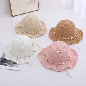 Straw sun hats for children with shell beads and wide wavy brims in four colors