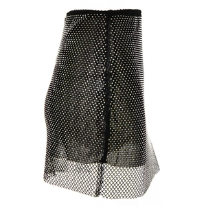 Detailed view of black mesh skirt with sparkling rhinestones and hollow-out texture