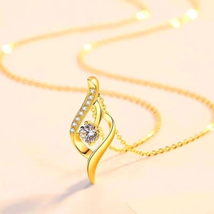 Detail shot of heart pendant with central round diamond and gold ripple design