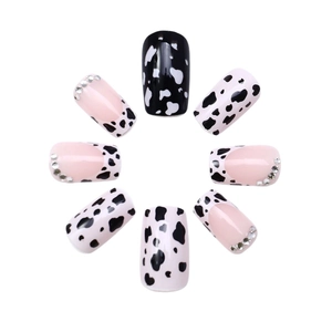Cow print press-on nails with pink French tips and rhinestones in square oval shape