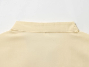 Detailed view of the beige poplin shirt collar featuring fine stitching and striped texture