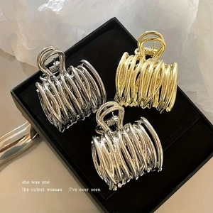 Hollow metal hair claw clips set in gold and silver spiral wire design for ponytails