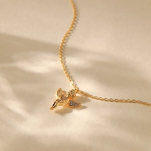 Close-up of a 18K gold plated angel pendant necklace with sparkling cubic zirconia wings