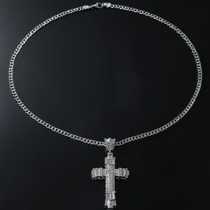 Macro shot of silver cross pendant necklace with sparkling clear cubic zirconia stones