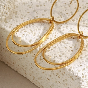 Detailed view of dual-layer oval hoop earrings in 18K gold-plated stainless steel