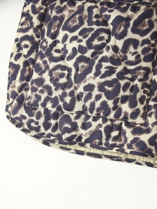 Close-up of leopard print quilted vest showing detailed stitching and edge hem fabric