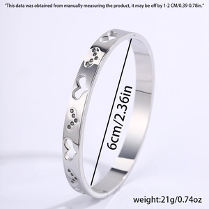 Detailed side view of silver heart cutout steel bangle showing 6cm diameter and 21g weight