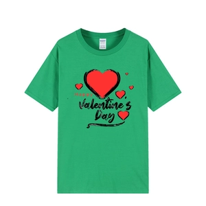 Close-up of Happy Valentine's Day red heart print on a green cotton crew neck t-shirt