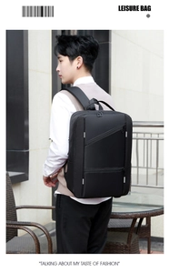 Outdoor shot of a black business laptop backpack with multiple zipper pockets on male model