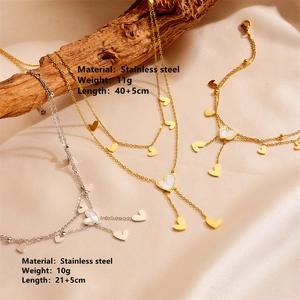 Detail of 18K gold and silver stainless steel heart pendants with shell inlay texture