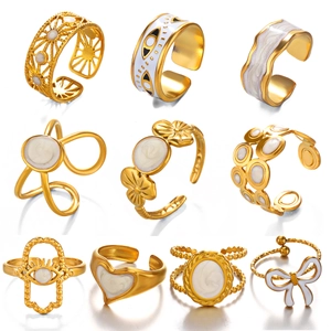 Minimalist gold titanium steel rings with white enamel designs in various geometric patterns