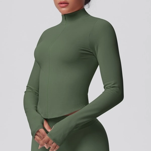 Detail view of the olive green yoga jacket featuring ribbed panels and functional thumbholes