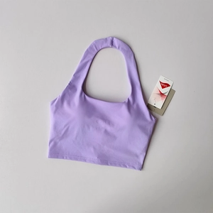 Detail of lavender halter sports bra featuring LYCRA fabric tag and ribbed texture