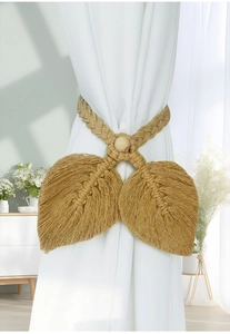 Detailed macro view of bohemian hand-woven macrame leaf curtain tiebacks with wood bead