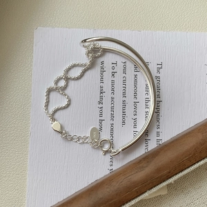 Detailed close-up of S925 sterling silver knotted bracelet with heart hollow links