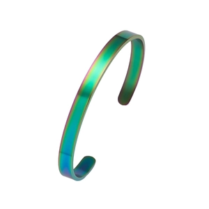 Macro shot of minimalist iridescent rainbow PVD finish on a stainless steel cuff bracelet