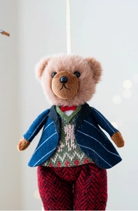 Close-up of plush bear pendants wearing British style checkered suits with gold lanyards