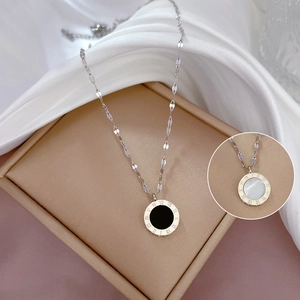 Detail of titanium steel necklace with black and white mother-of-pearl roman numerals