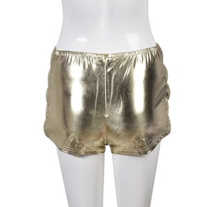 Detail of high-stretch gold metallic short pants with invisible zipper and glossy finish