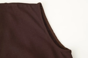 Close-up of precise stitching and texture on a dark brown sleeveless mini dress