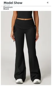 Detail of high waisted black flared yoga pants featuring side drawstring and pleated waist