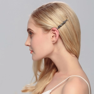 Sparkling black rhinestone hair clip worn by model for an elegant minimalist style
