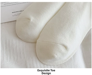 Close-up of reinforced seamless toe stitching on white cotton athletic crew socks