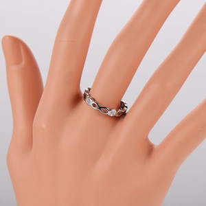 Close-up of infinity symbol ring with crystal stones on a model hand display