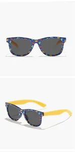Detail of blue kids dinosaur print sunglasses with contrast yellow arms and grey lenses
