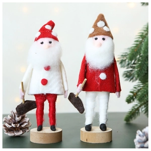 Detail of handcrafted Christmas wool felt Santa figures on wooden bases for festive decor
