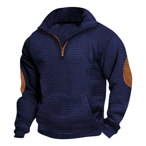 Detail of dark blue waffle knit hoodie with brown faux leather elbow patches and zipper accents