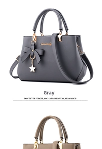Detail of grey and khaki textured leather handbags with bow and star pendants